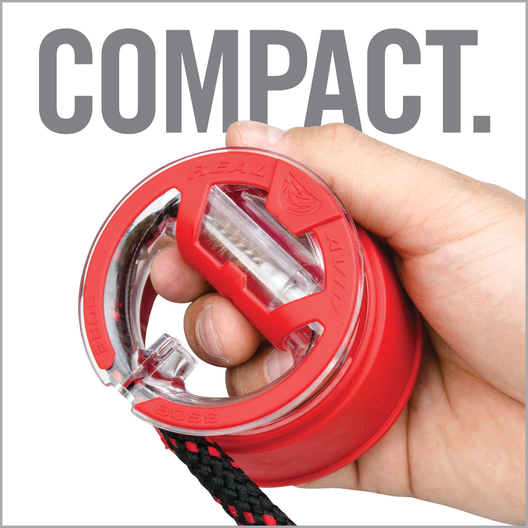 a hand holding a red and black object with the words compact on it